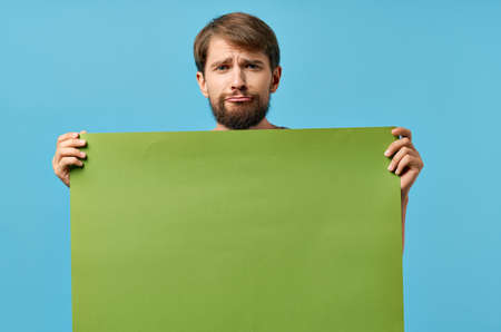 emotional bearded man green banner blue background