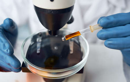 microscope and liquid on glass bacteria chemical element hospital vaccinationの写真素材