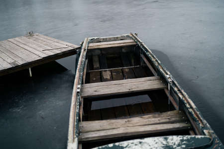 old wooden boat in the river near the pier nature landscapeの写真素材