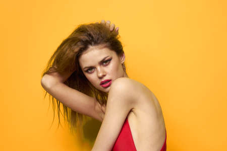 Pretty woman with wavy hair wearing red tank topの写真素材