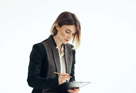 Woman in a suit In a bright room with documents in handsの写真素材