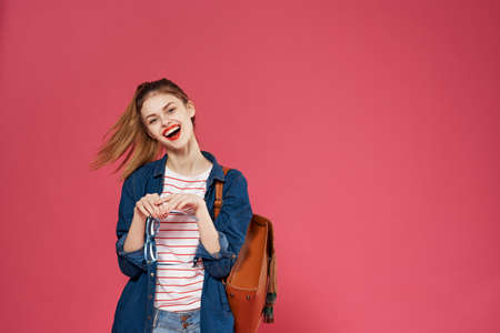 Pretty woman fashionable clothes studio backpack cropped view pink background
