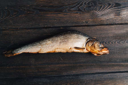 dried fish lies on a wooden table top view texture