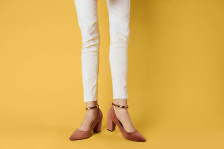 Female feet fashion shoes luxury yellow background