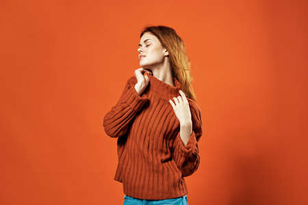 woman in red sweater and jeans casual wear fashion studio isolated background