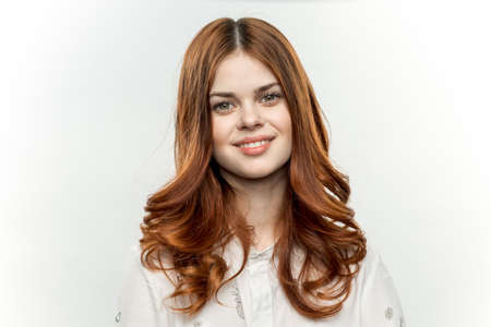 pretty woman with red hair smile cosmetics glamor light background