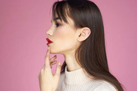 Beautiful brunette red lips white blouse close-up attractive view pink background