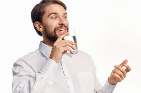 nice guy drinking water from a glass and gesturing with his hands