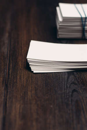 stack of white business cards and pen on office desk wooden backgroundの写真素材