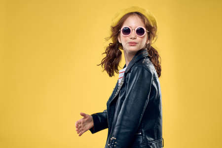 Girl in a yellow hat dark glasses fashionable clothes studio lifestyle childhood