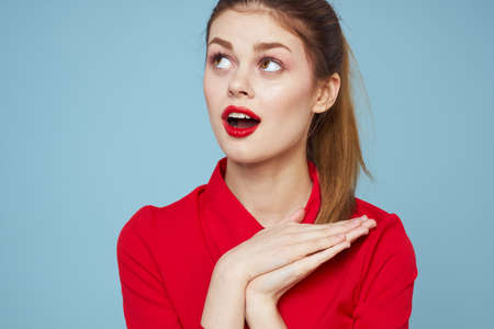 Pretty woman red shirt glamor dark glasses blue background