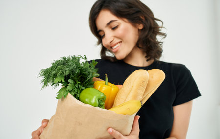 Woman with package of healthy food supermarket shoppingの写真素材
