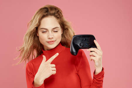 Woman in red sweater game console game entertainmentの写真素材
