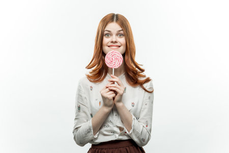emotional woman with lollipop in hands joy sweets lifestyle cropped viewの写真素材
