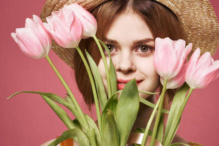 Woman in a hat bouquet of flowers close-up womens day