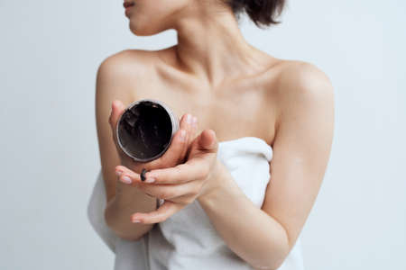Woman in white towel black cream healthy skin dermatologyの写真素材