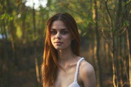woman near trees in garden white dress summer vacation natureの写真素材
