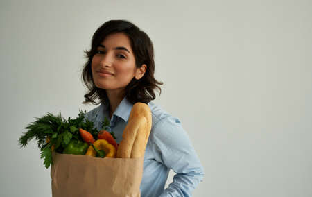 cheerful woman with a package of healthy food fresh productsの写真素材