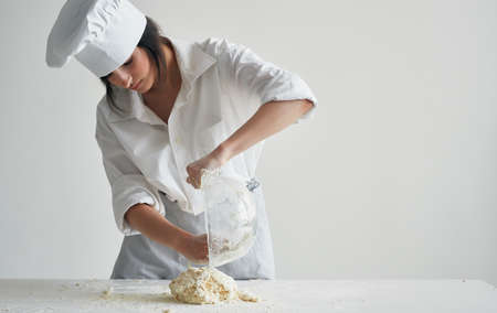 Woman chef preparing dough household healthy foodの写真素材