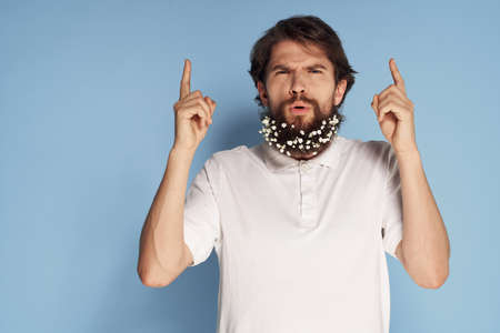 Man t-shirt flowers in beard decoration emotions blue backgroundの写真素材