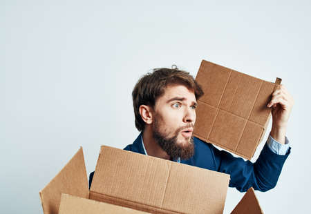 man with boxes in groups moving new place of work lifestyle officialの写真素材