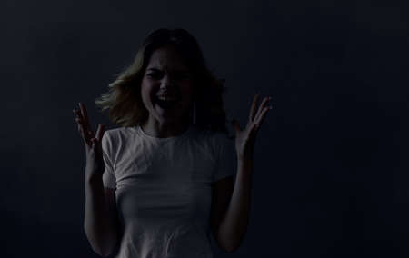 Emotional woman gestures with her hands discontent gray backgroundの写真素材