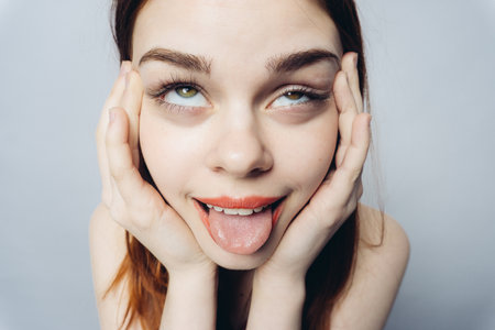 emotional woman holding hands on face emotions antics close-upの写真素材