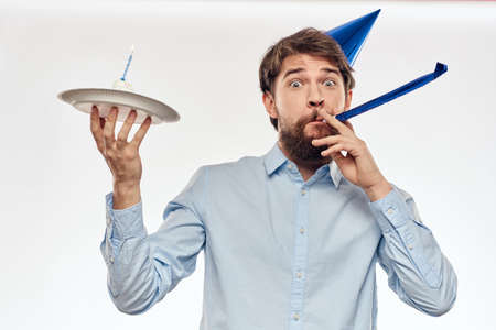 Happy guy with birthday cake white background Compact corporate party cropped beard viewの写真素材