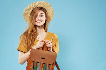 Cheerful woman in backpack hat fashion cropped view