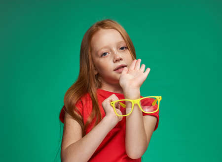 girl with red hair and glasses training school green background