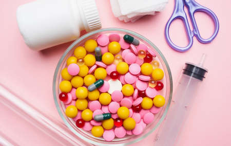 mountain multicolored pills first aid kit packaging pink health background