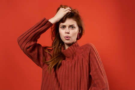 pretty woman in red sweater decoration fashion hairstyle glamor red background