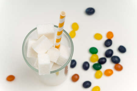 sugar cubes in a glass with a straw calories cocktail glucose sweetsの写真素材