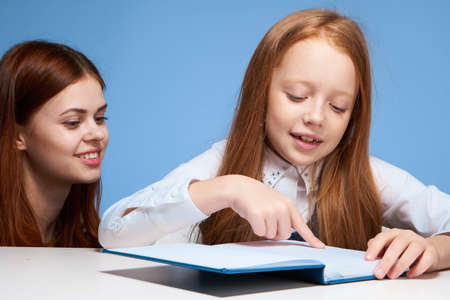 red-haired girl doing homework at home education learningの写真素材