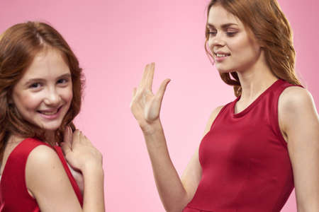 Family mom and daughter games lifestyle fun Friendship pink background