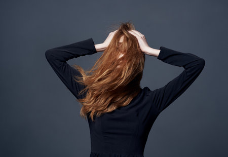Beautiful elegant woman holding her hair glamor cropped close-up viewの写真素材