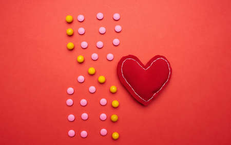 multicolored pills on red background medicine healthの写真素材