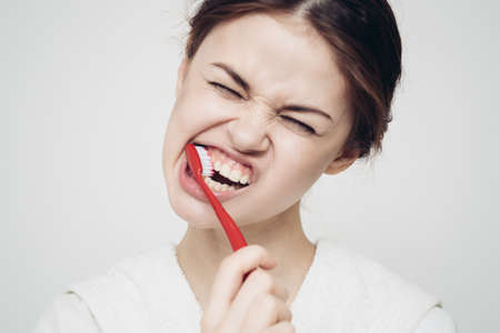 pretty woman toothbrush in hand in the morning oral hygieneの写真素材