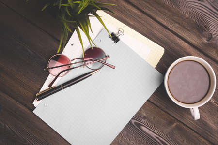 notepad for notes on the table and glasses pen office flower potted coffee cupの写真素材
