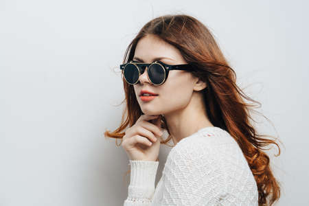 woman fashion glasses white sweater cropped view studio