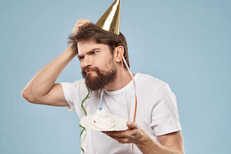Bearded man with a cap on his head holiday gift cakeの写真素材