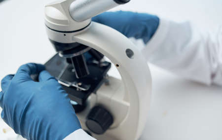 microscope research medical gown woman doctor gloves laboratoryの写真素材
