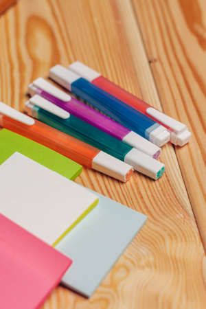 multicolored markers paper office school items wooden table