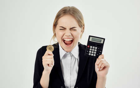 emotional woman with calculator cryptocurrency bitcoin financialの写真素材