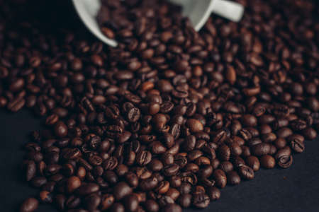 cup of coffee with brown beans on a gray background close-ups macro photographyの写真素材