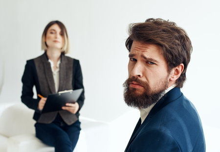 and emotional man at job interview and business woman in suit in the backgroundの写真素材