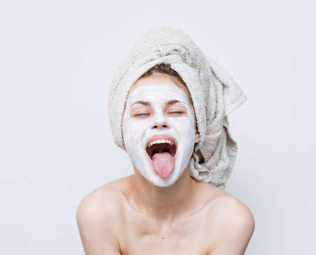 cheerful woman with face mask clean skin hygiene bare shouldersの写真素材