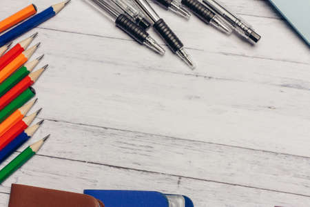 multicolored business card holders on a wooden table and markers pencils stationery pensの写真素材