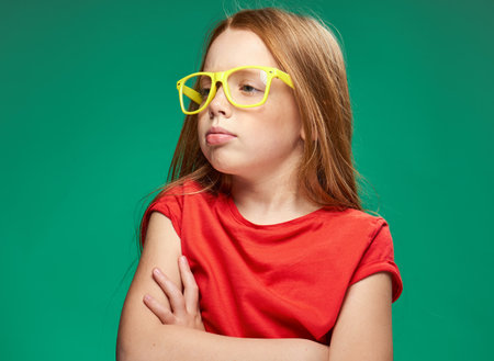 cute girl red hair glasses education school green background