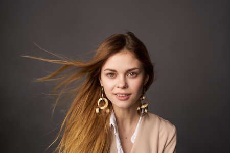 pretty red-haired woman elegant clothes earrings jewelry Luxury gray backgroundの写真素材